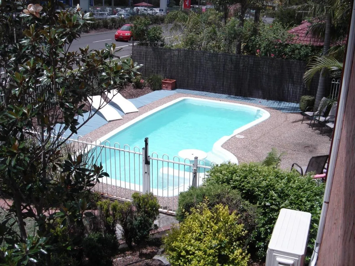 The kidney shaped solar heated pool seen from above, surrounded by garden and sun lounges